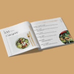 Pages intérieurs de la brochure haut de gamme pour Le Baron Traiteur représentant une partie du menu sur fond ocre